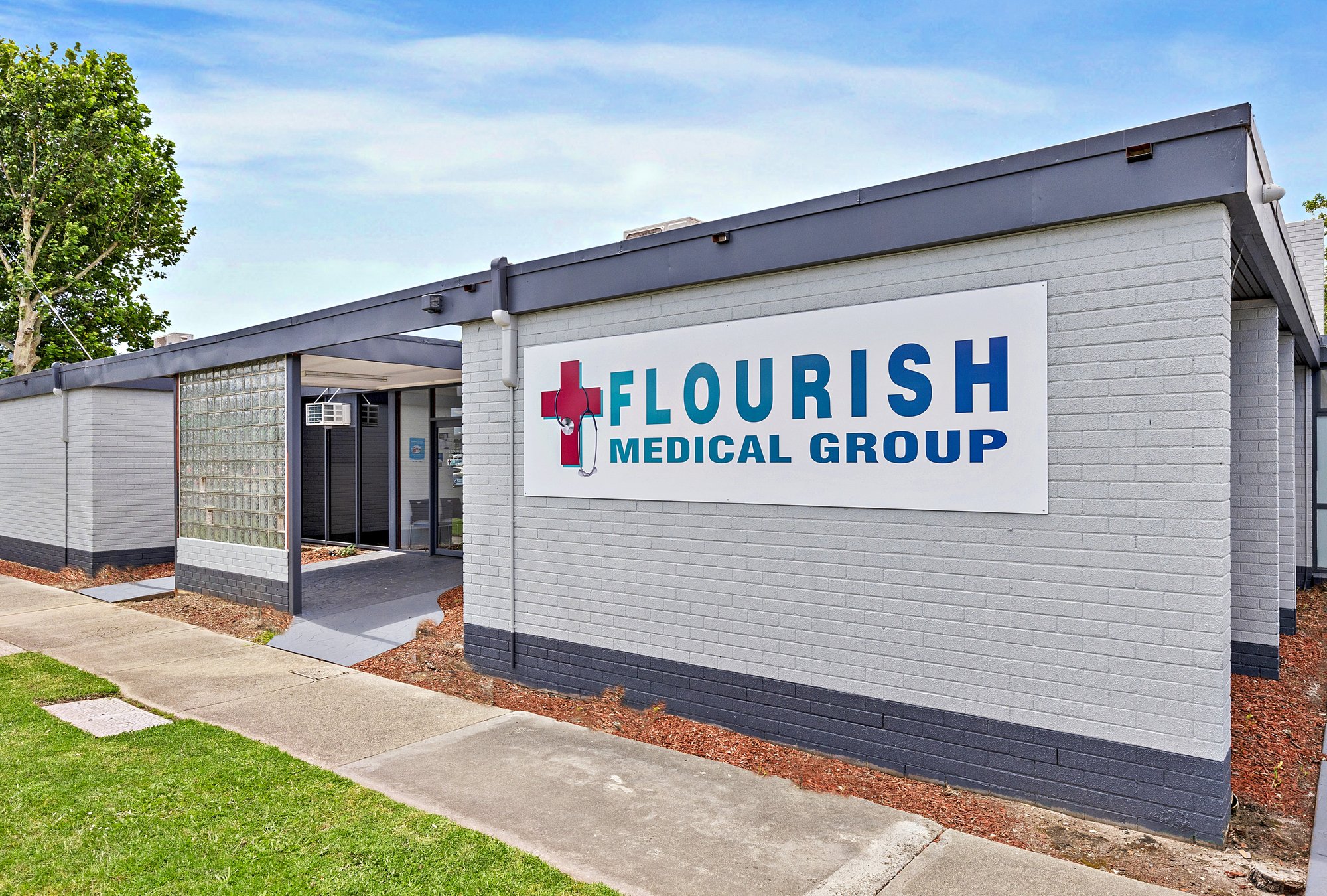The Flourish Medical Group building on Deakin Street, Traralgon, with its sign on the brick wall